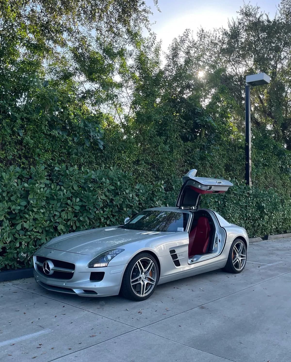 A silver collector car presented with both doors open