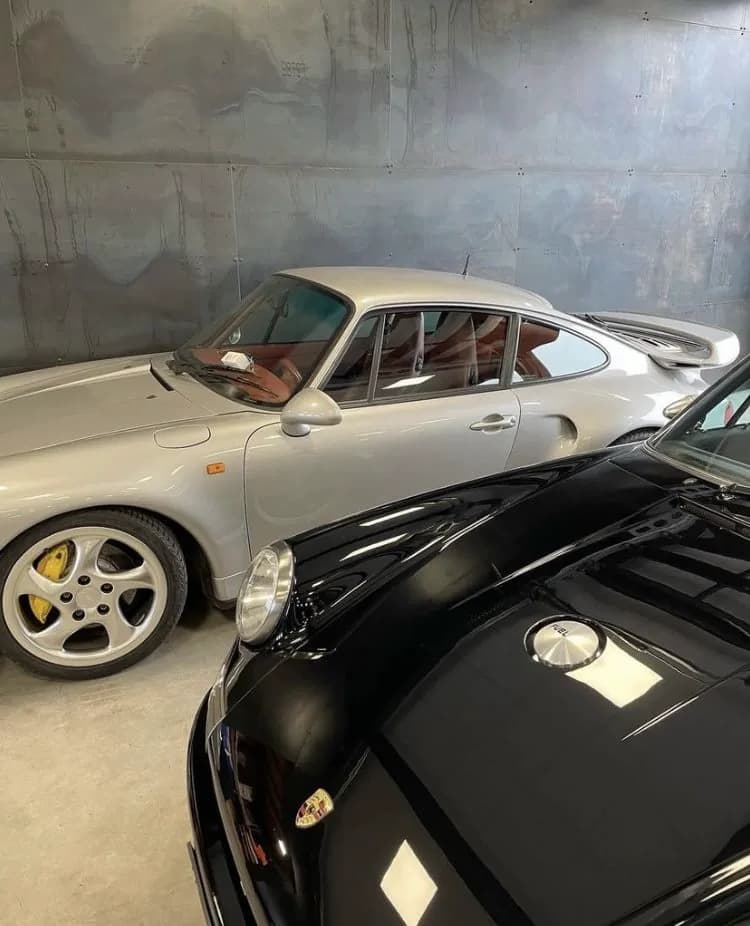 Two Porsche 911s prepared together indoors