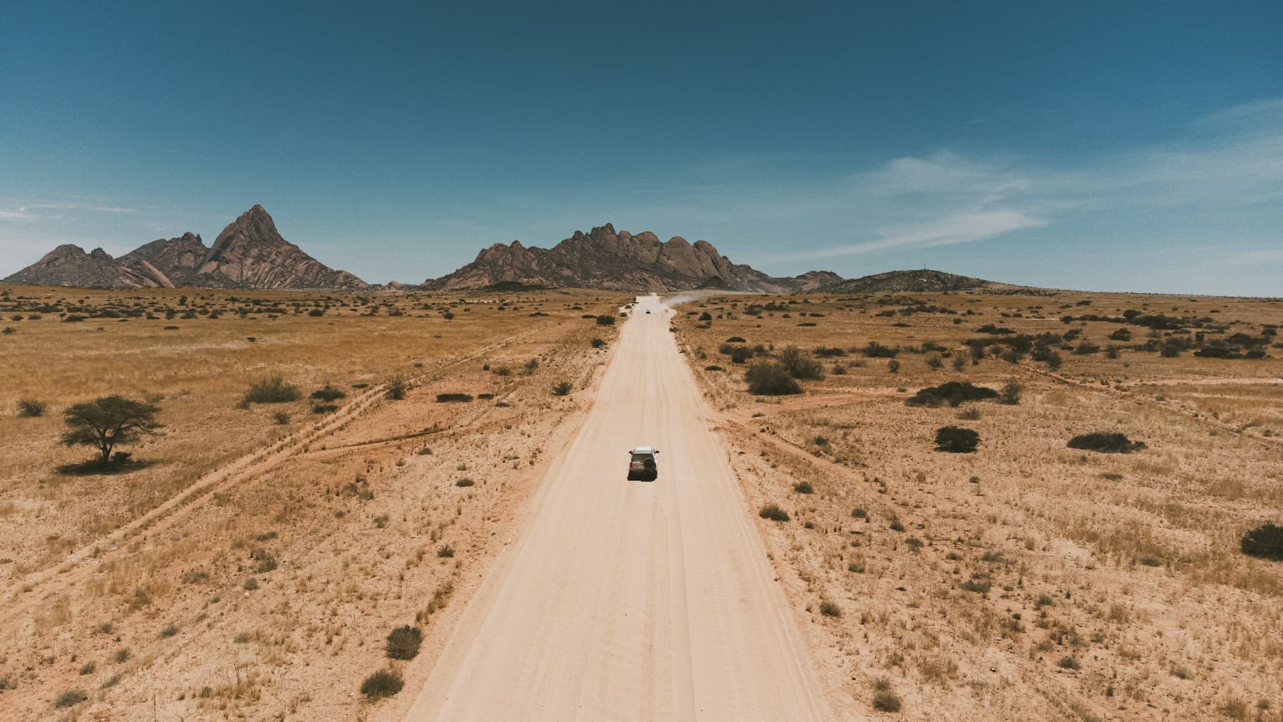 Long remote road used as a cinematic drive planning visual