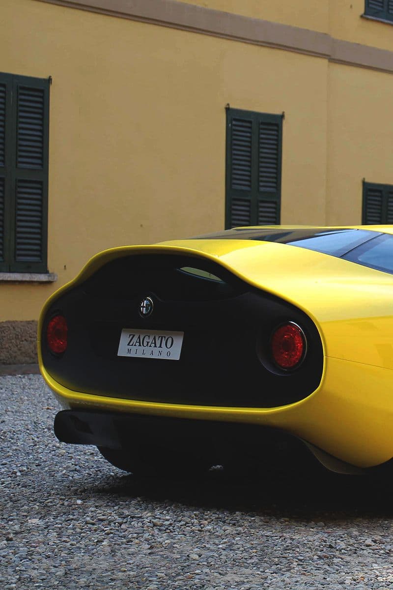 The rear profile of a yellow Alfa Romeo Zagato